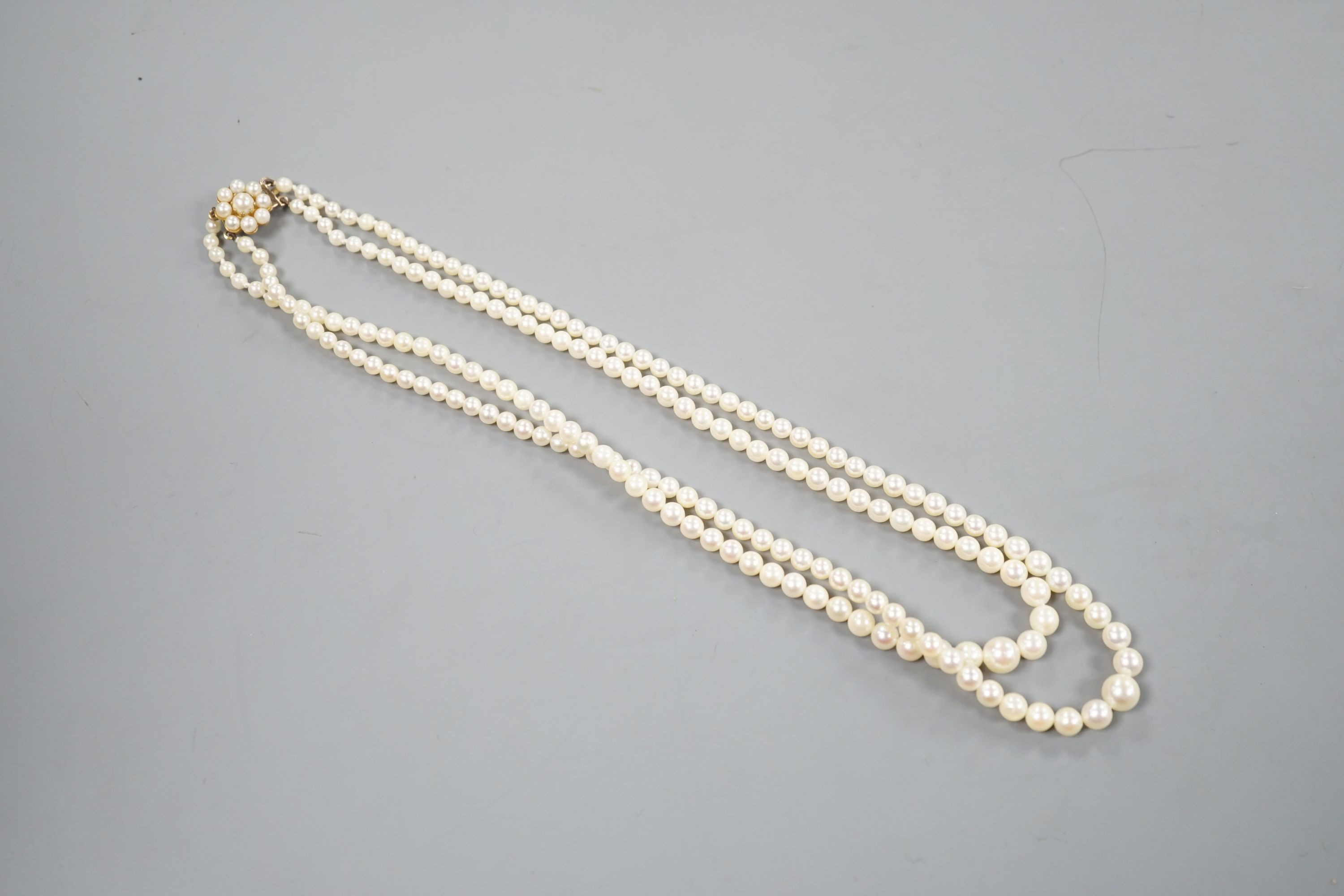 A double strand graduated cultured pearl necklace, with a 9ct and cultured pearl set clasp, 44cm.